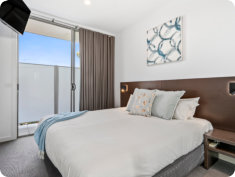 Main Bedroom with King Size Bed with Quilts | Luxury Penthouse Apartment